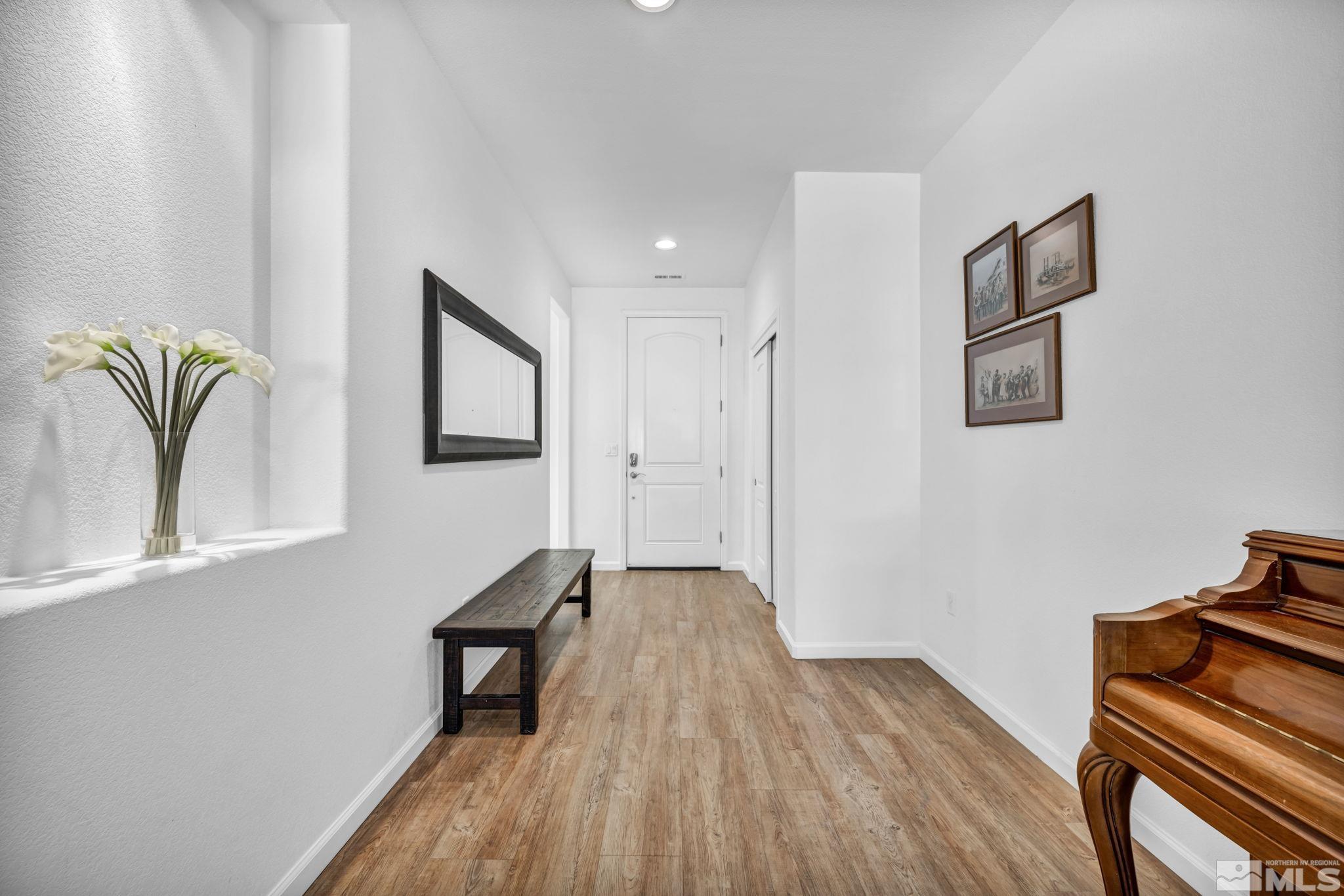 2197 Berkich Court Reno, NV 89521 - Photo 18 of 40 a view of a hallway with wooden floor and furniture