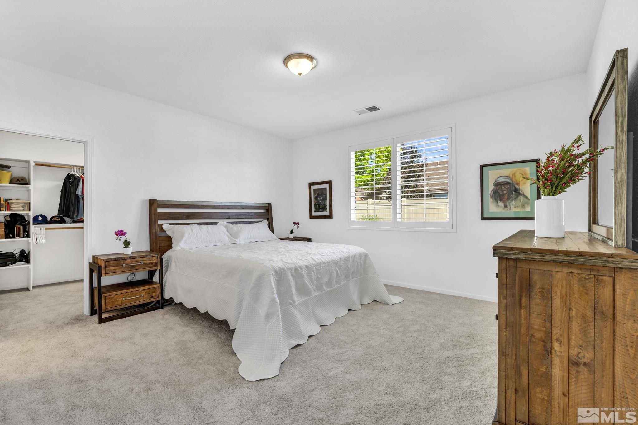2197 Berkich Court Reno, NV 89521 - Photo 19 of 40 a bedroom with a bed and dresser with mirror