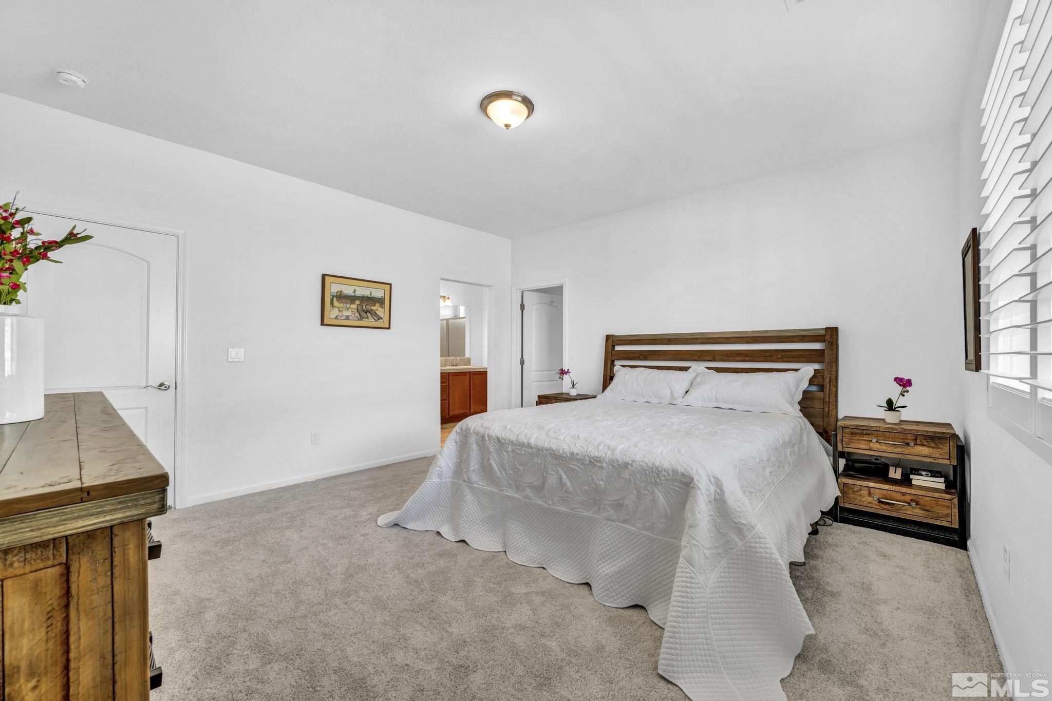 2197 Berkich Court Reno, NV 89521 - Photo 20 of 40 a bedroom with a bed and a night stand