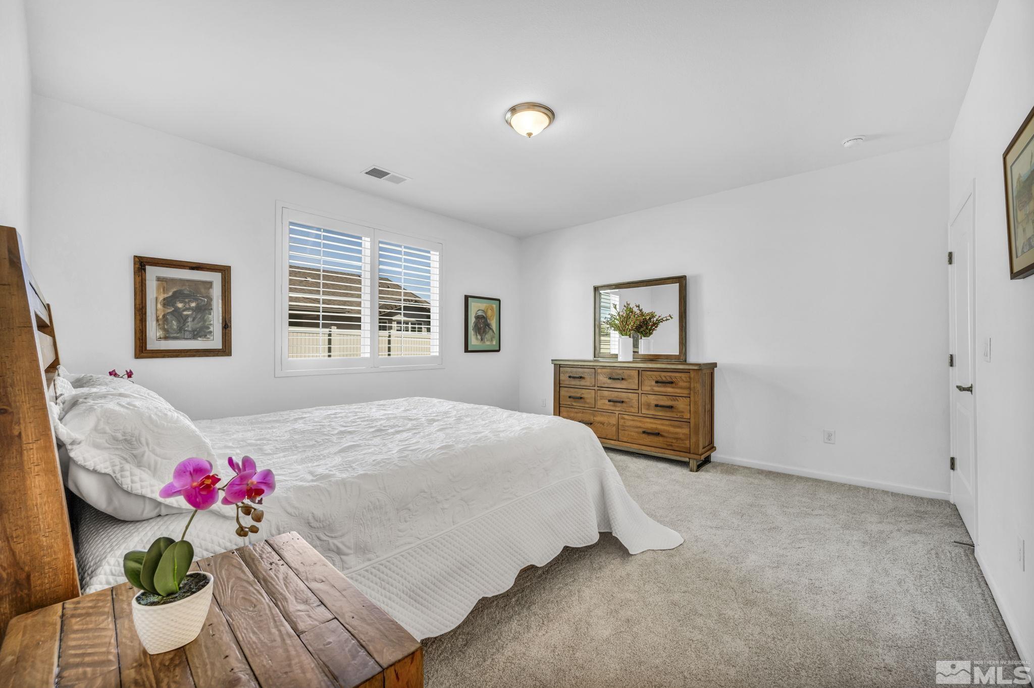 2197 Berkich Court Reno, NV 89521 - Photo 21 of 40 a bedroom with a bed dresser and window