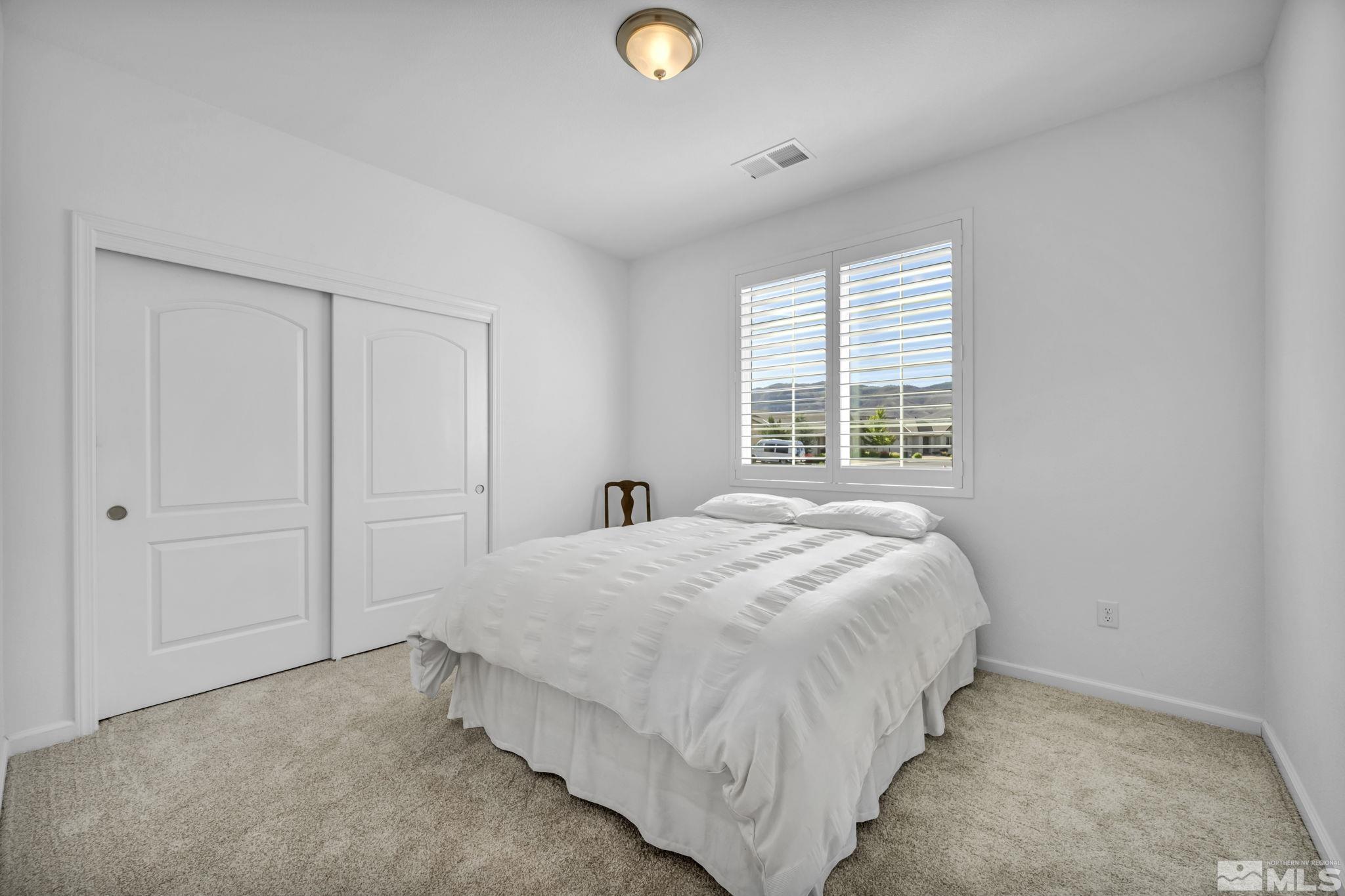 2197 Berkich Court Reno, NV 89521 - Photo 23 of 40 a bedroom with a bed and a window