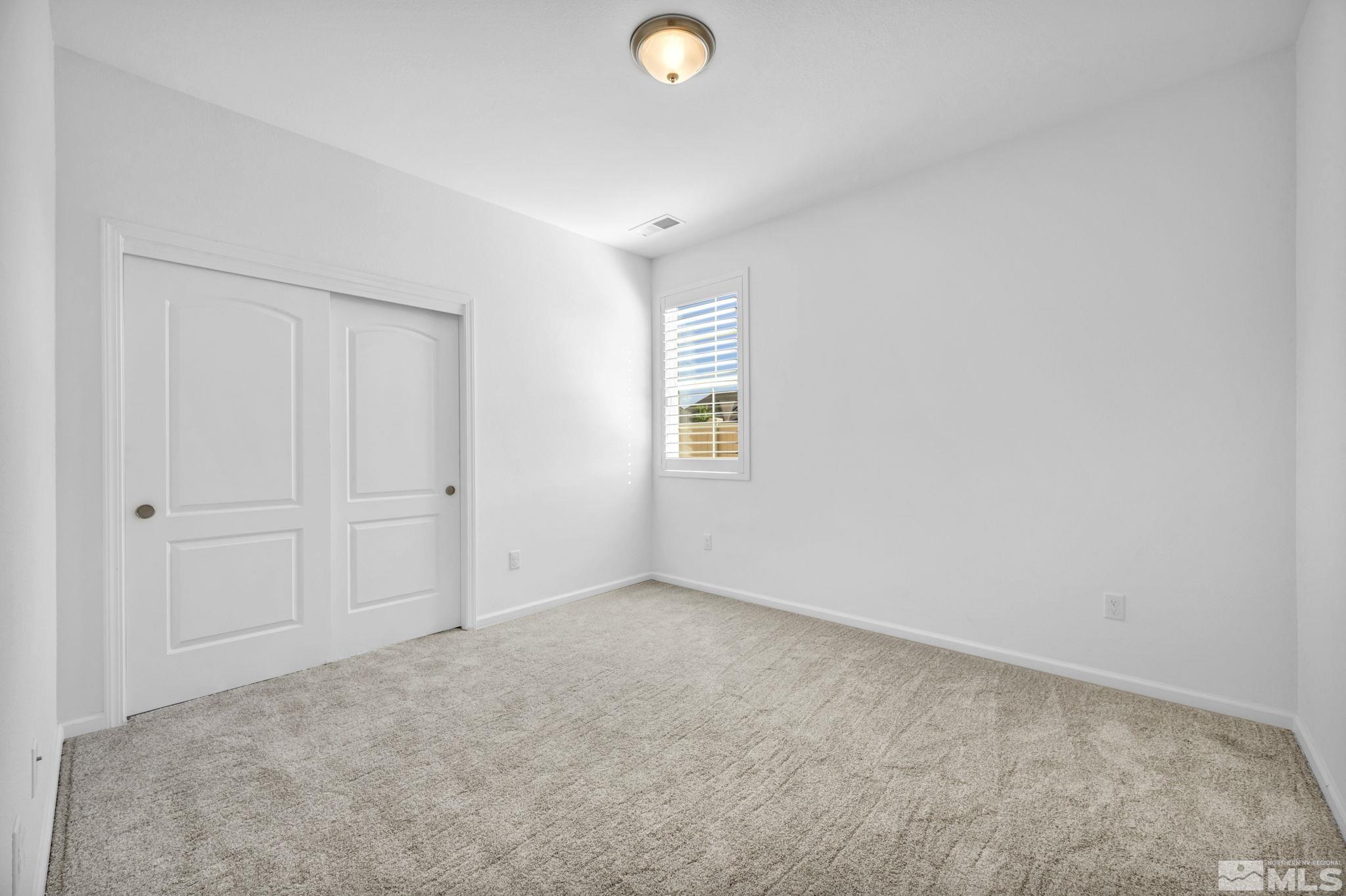 2197 Berkich Court Reno, NV 89521 - Photo 24 of 40 an empty room with windows and closet