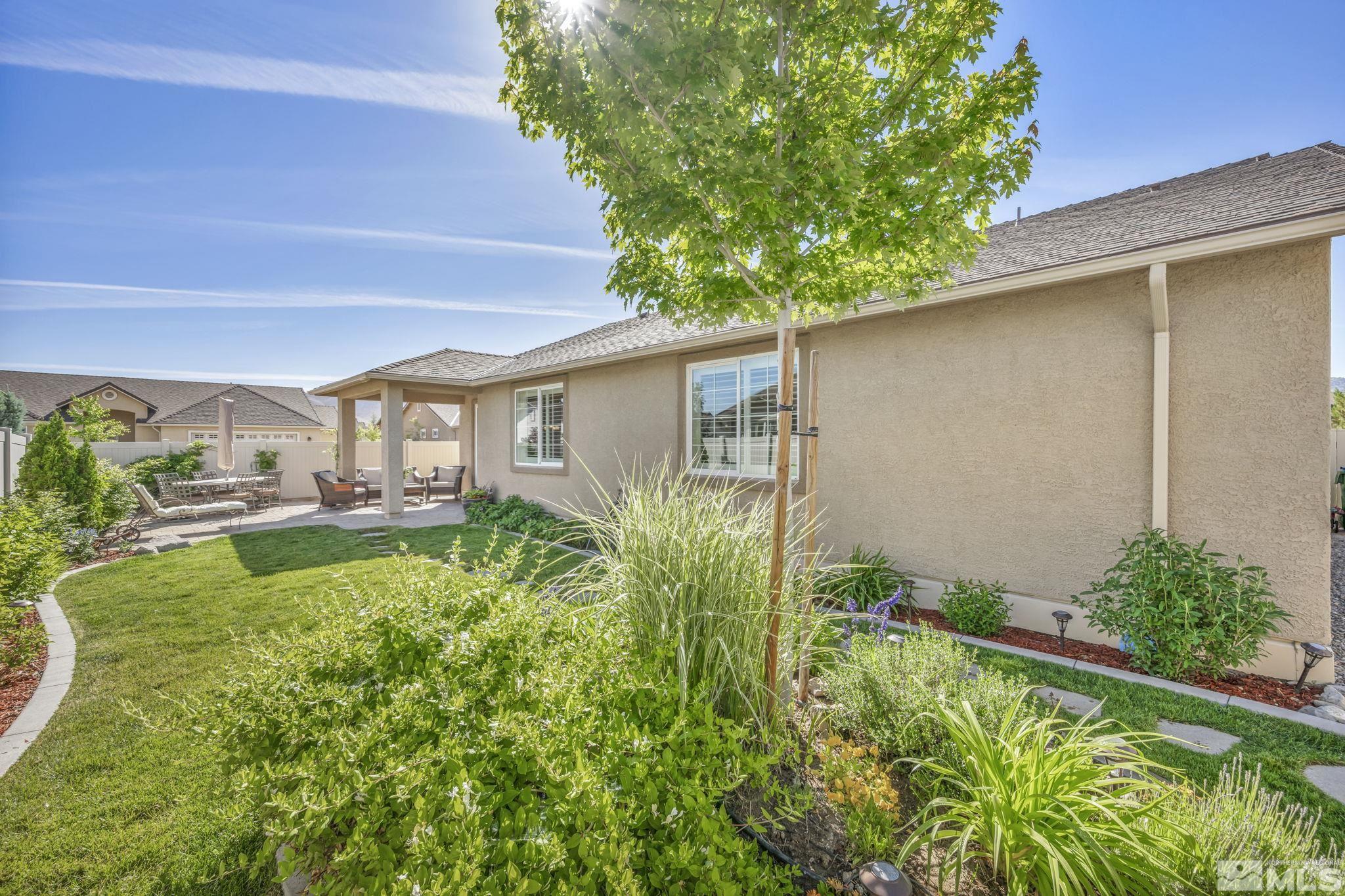2197 Berkich Court Reno, NV 89521 - Photo 34 of 40 a backyard of a house with plants and outdoor seating