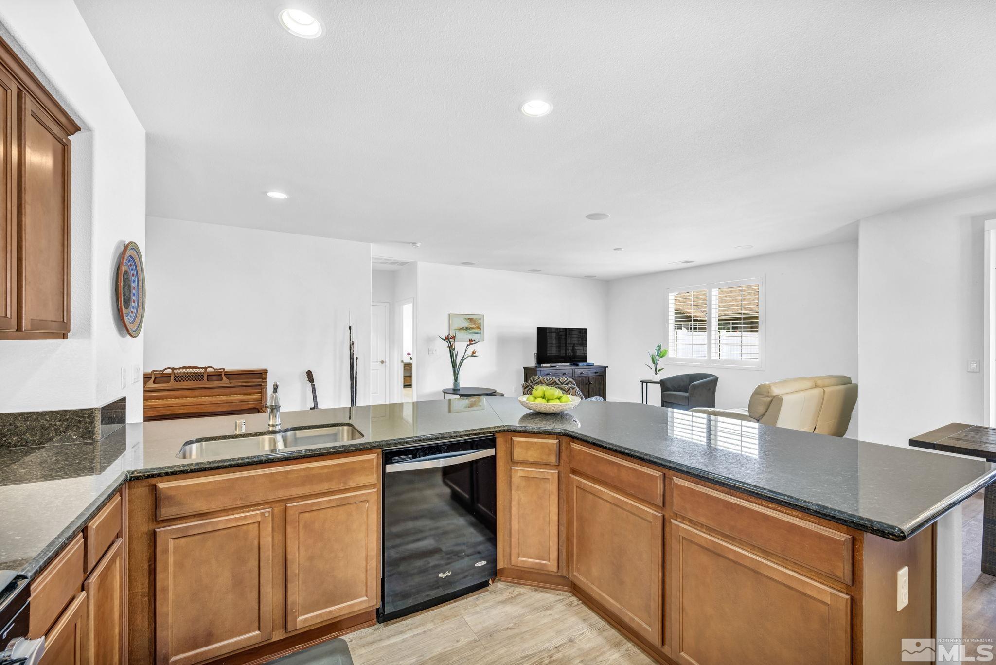 2197 Berkich Court Reno, NV 89521 - Photo 6 of 40 a kitchen with stainless steel appliances granite countertop a sink stove and refrigerator