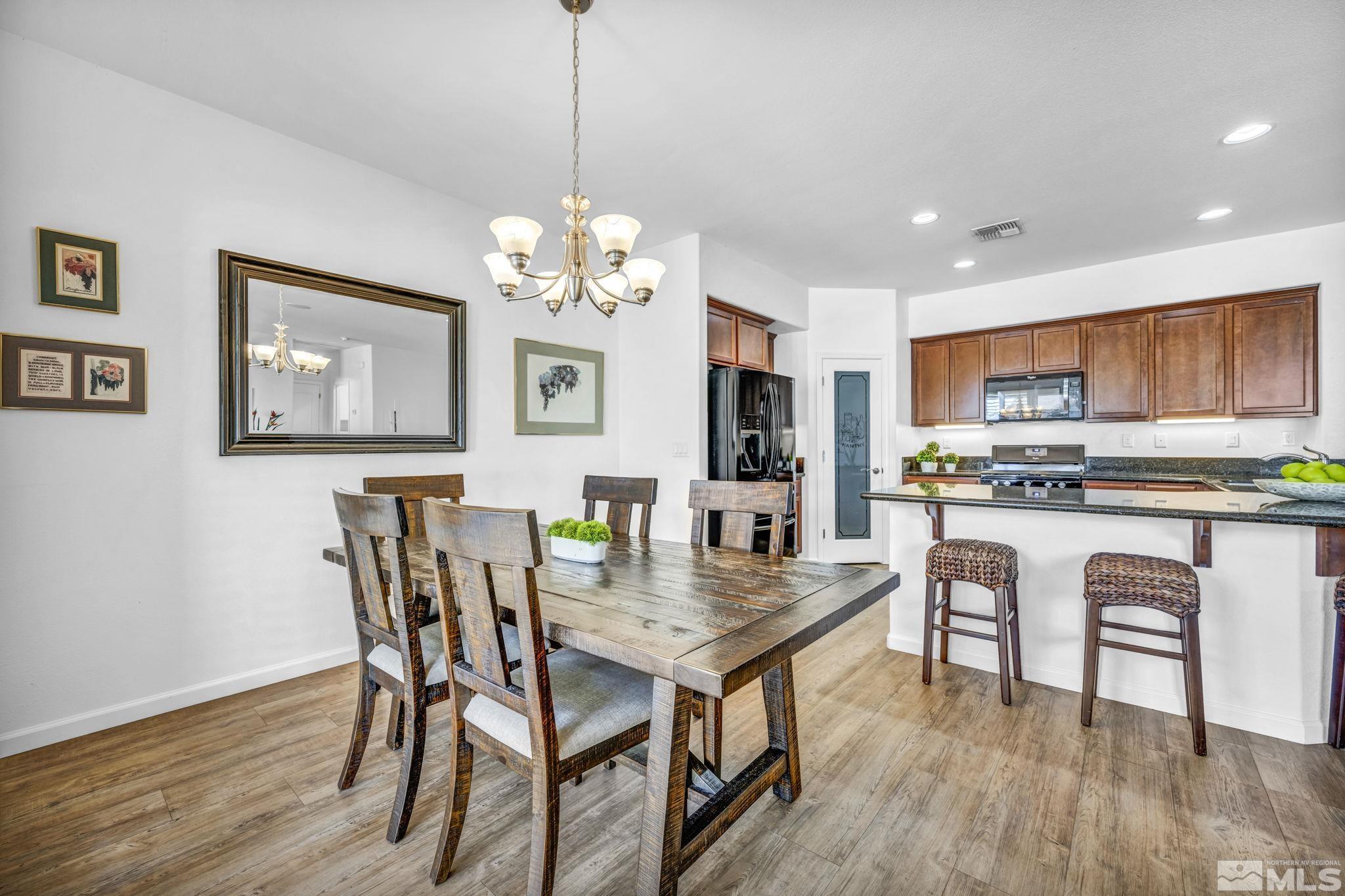 2197 Berkich Court Reno, NV 89521 - Photo 10 of 40 a view of a dining room with furniture window and wooden floor