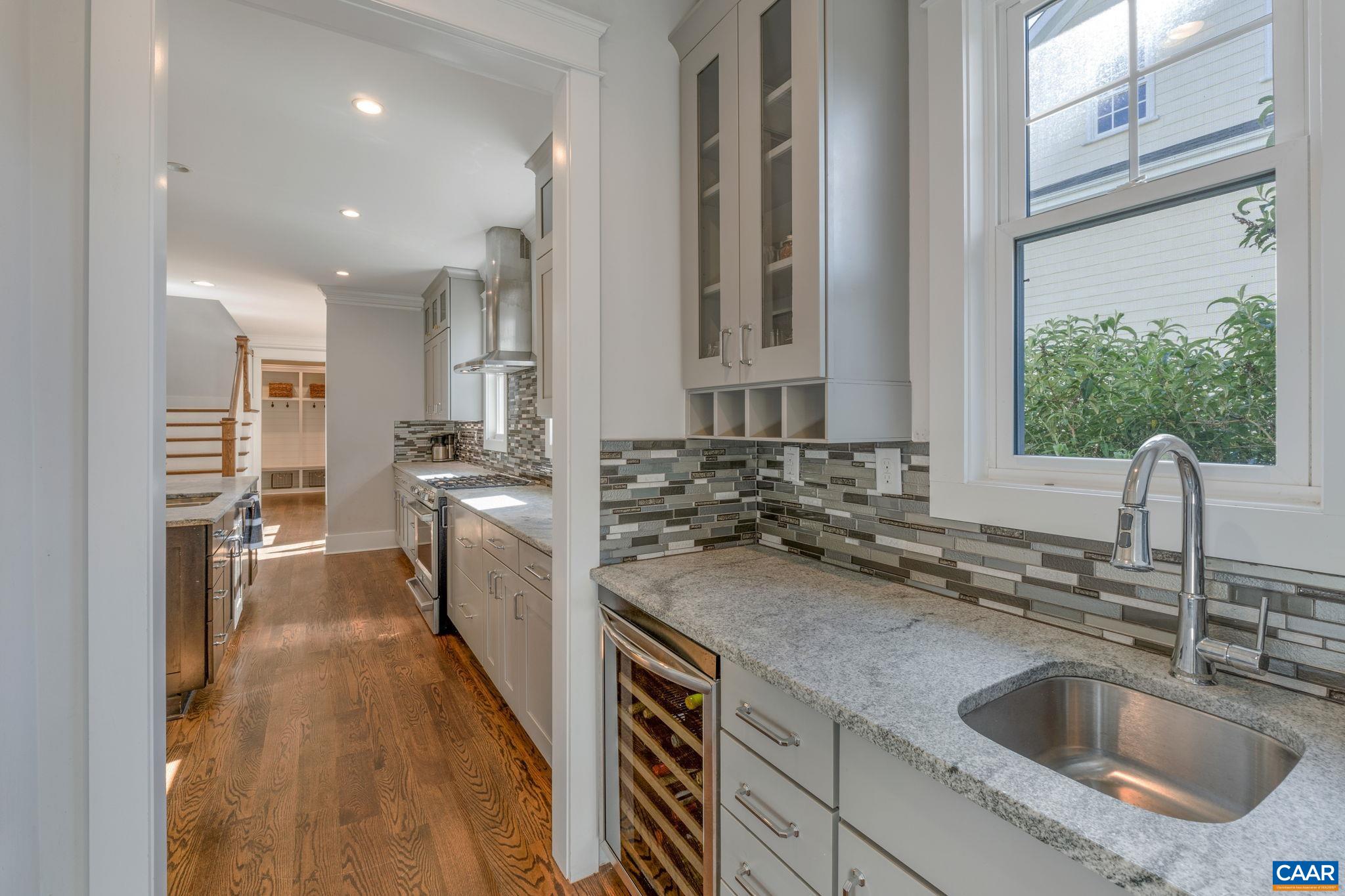 5123 Brook View Road Crozet, VA 22932 - Photo 16 of 75 a kitchen with kitchen island a sink a counter top space stainless steel appliances and a window
