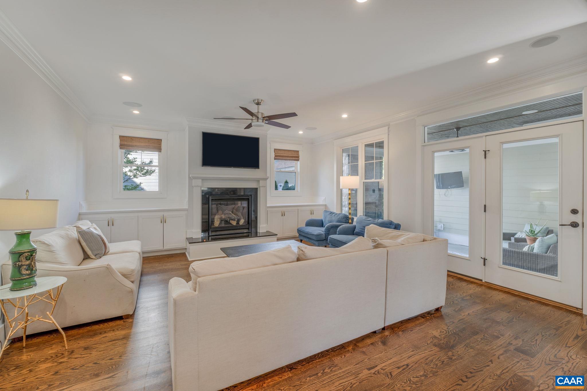 5123 Brook View Road Crozet, VA 22932 - Photo 23 of 75 a living room with furniture a flat screen tv and a fireplace