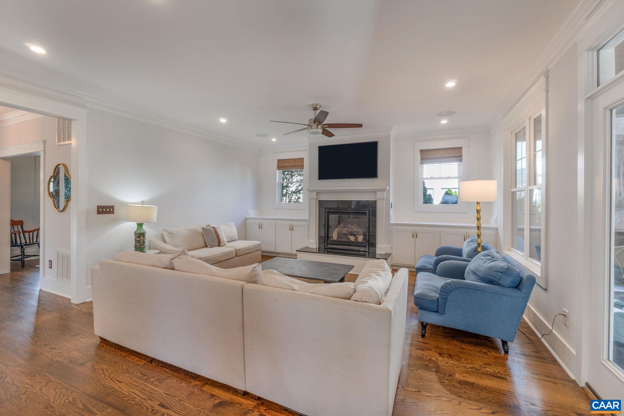 5123 Brook View Road Crozet, VA 22932 - Photo 25 of 75 a living room with furniture a fireplace and a flat screen tv