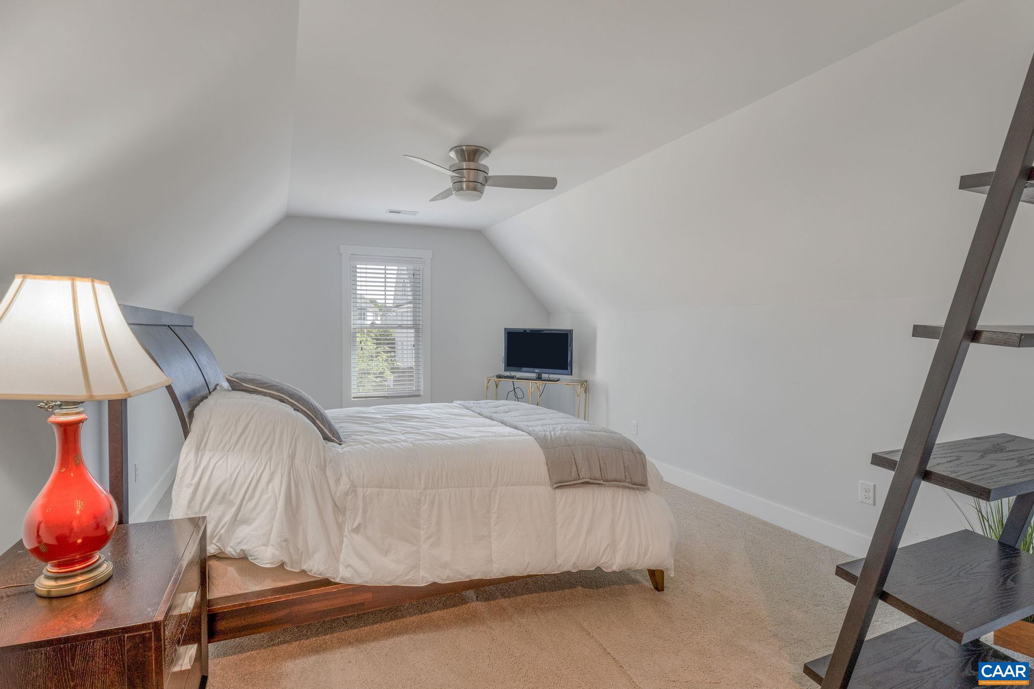 5123 Brook View Road Crozet, VA 22932 - Photo 38 of 75 a bedroom with a bed and a chandelier