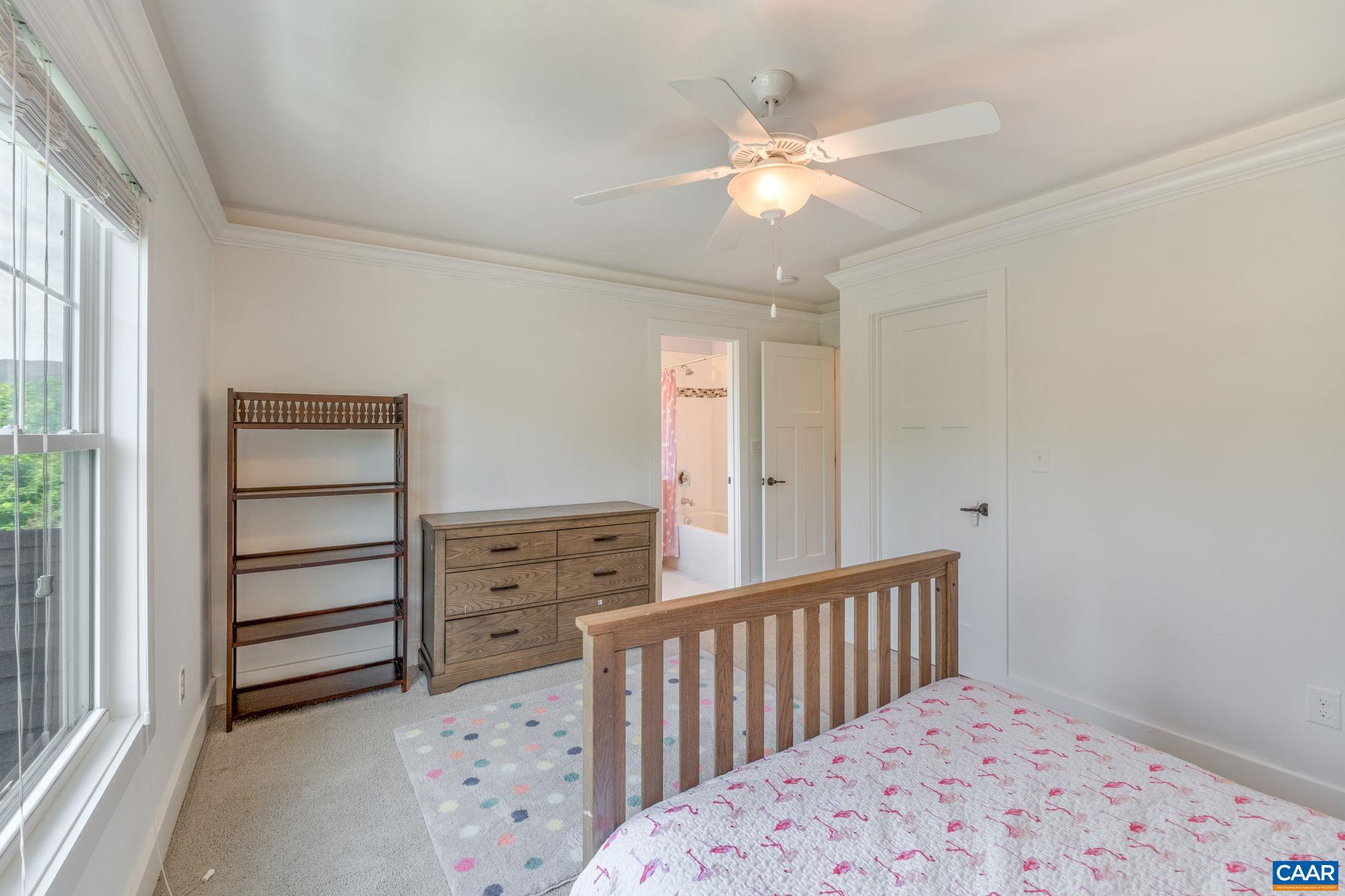 5123 Brook View Road Crozet, VA 22932 - Photo 52 of 75 a bedroom with a bed and a chandelier fan
