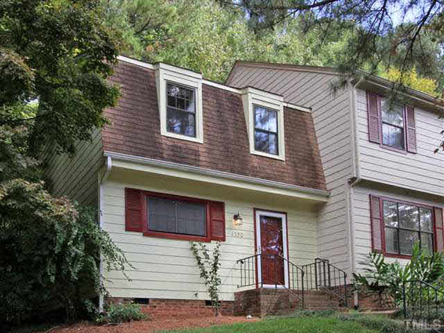 1330 Springlawn Court Raleigh, NC 27609 - Photo 1 of 19 a front view of a house with plants
