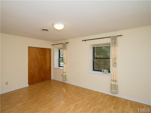 1330 Springlawn Court Raleigh, NC 27609 - Photo 11 of 19 an empty room with windows and closet