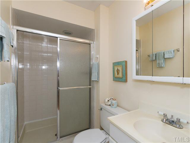 1330 Springlawn Court Raleigh, NC 27609 - Photo 13 of 19 a bathroom with a sink toilet and shower