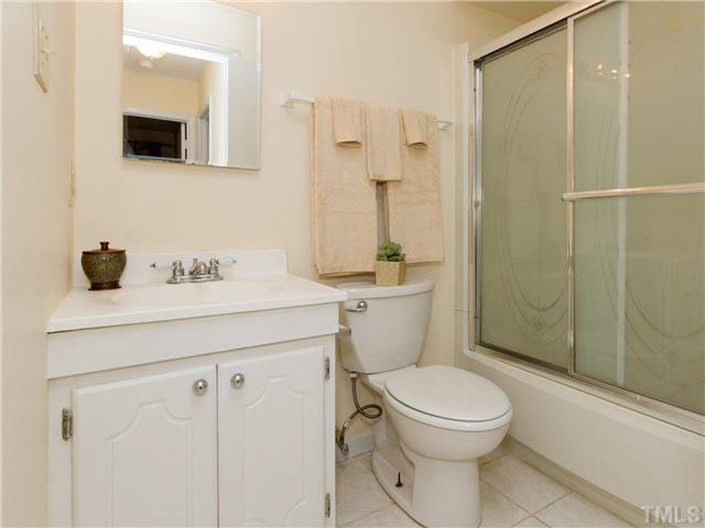 1330 Springlawn Court Raleigh, NC 27609 - Photo 16 of 19 a bathroom with a sink a toilet and shower
