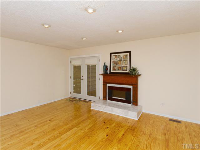 1330 Springlawn Court Raleigh, NC 27609 - Photo 4 of 19 a view of empty room with a fireplace