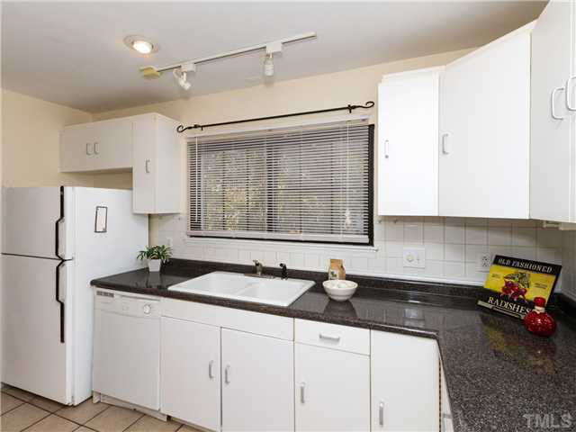 1330 Springlawn Court Raleigh, NC 27609 - Photo 7 of 19 a kitchen with sink cabinets and a window