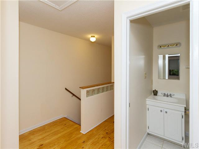 1330 Springlawn Court Raleigh, NC 27609 - Photo 10 of 19 a view of bathroom with a sink mirror and window