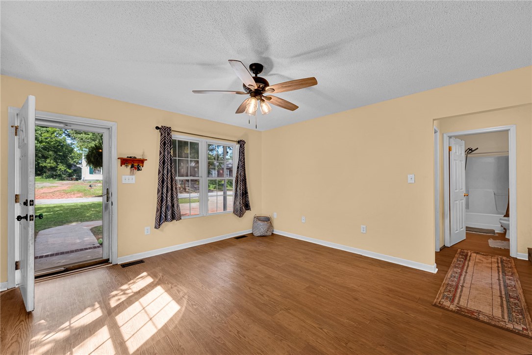 1020 Elizabeth Street Anderson, SC 29624 - Photo 7 of 22 Warm wood-look flooring and ample natural light define this inviting living space.