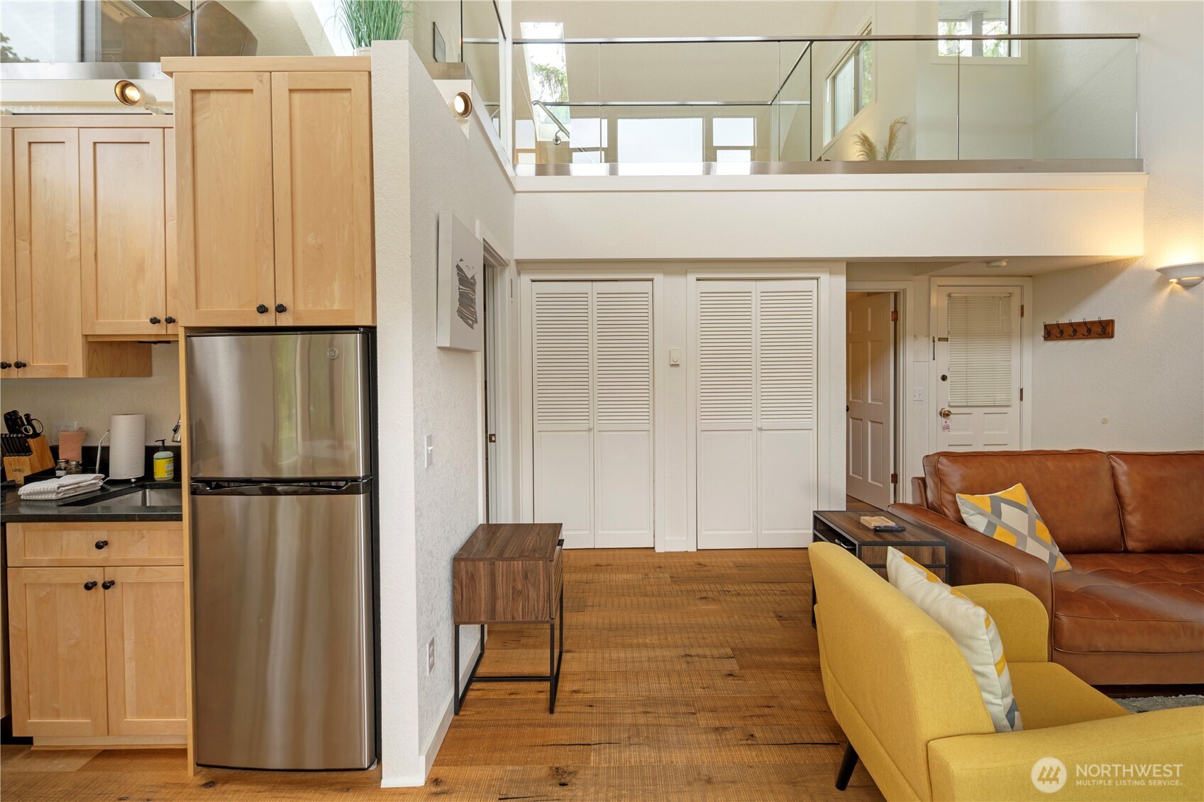 98 Armadale Road, Unit 215 Friday Harbor, WA 98250 - Photo 7 of 39 a living room with furniture and a refrigerator