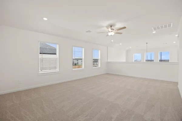 a view of an empty room with a kitchen