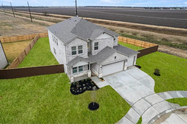 a aerial view of a house with a yard