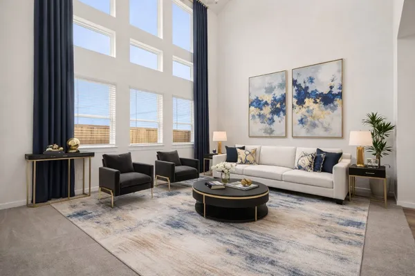 a living room with furniture and a floor to ceiling window