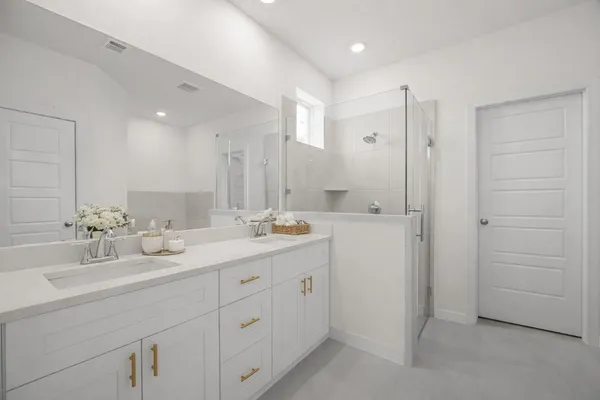 a bathroom with a double vanity sink and mirror