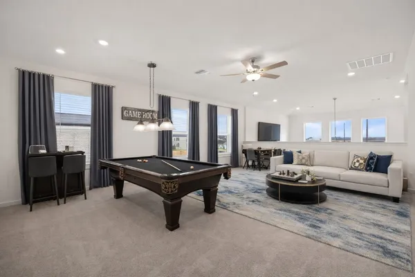 a living room with furniture gym equipment and a window