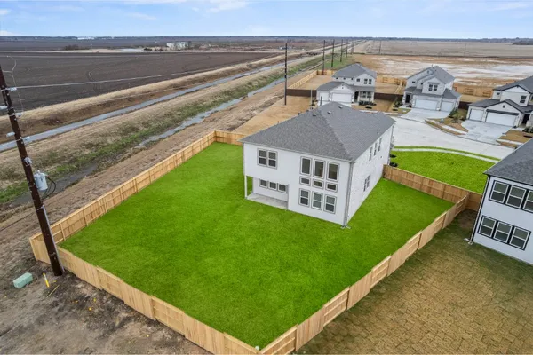 a view of a house with a yard and sitting area