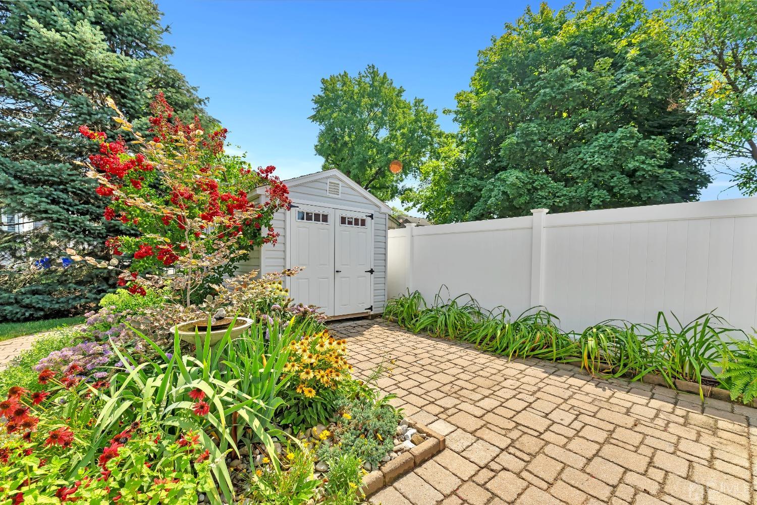 3237 Banta Road South Plainfield, NJ 07080 - Photo 23 of 26 a bunch of flowers in front of yellow house
