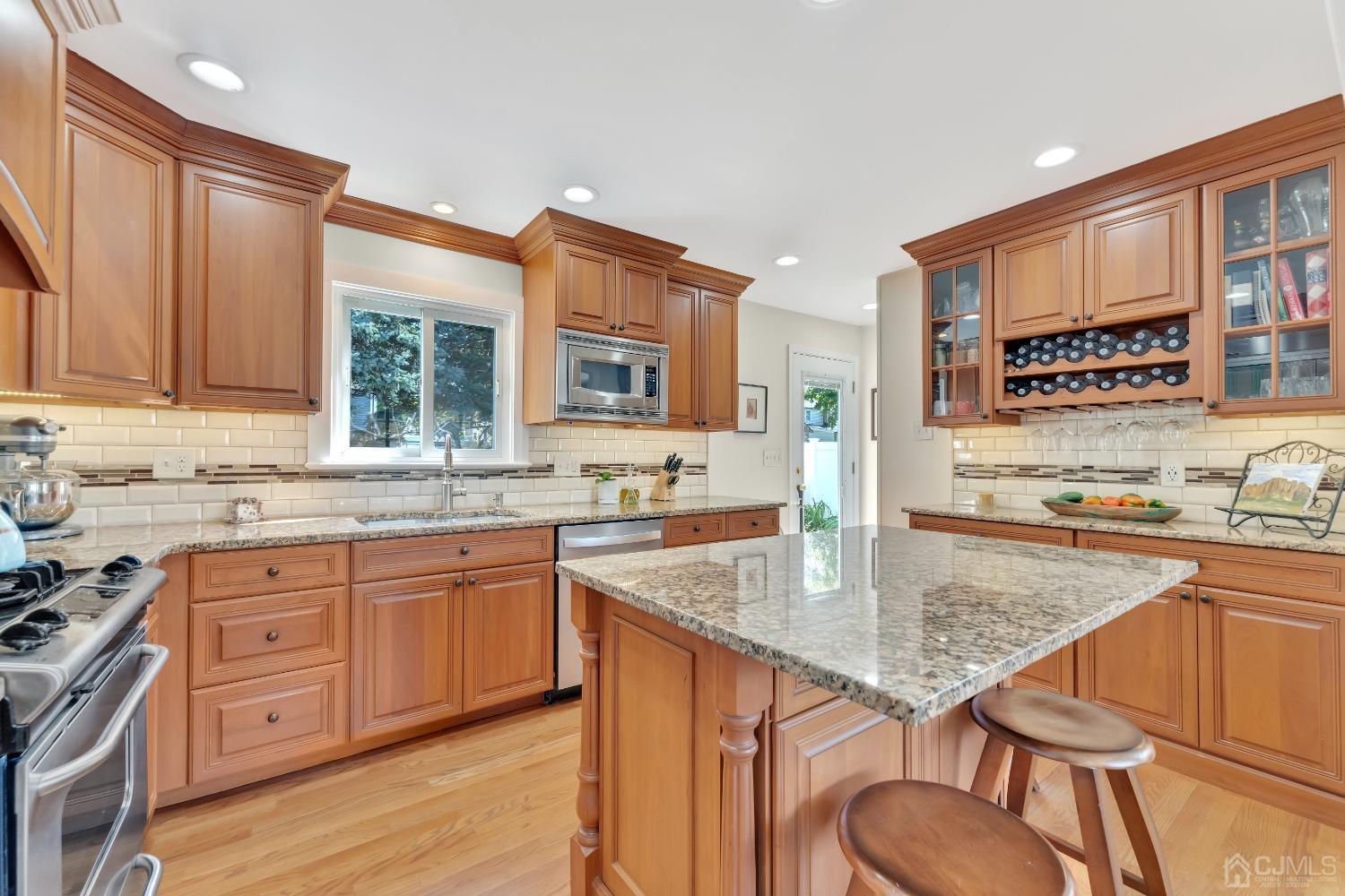 3237 Banta Road South Plainfield, NJ 07080 - Photo 8 of 26 a kitchen with stainless steel appliances granite countertop a sink stove and wooden cabinets
