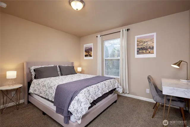 a bedroom with a bed and a table in it