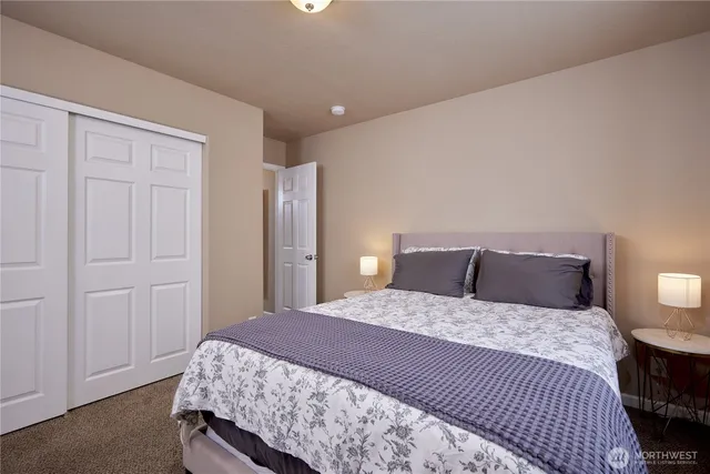 a bedroom with a bed and a closet