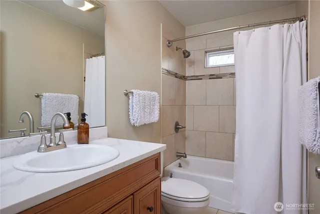 a bathroom with a sink toilet tub and shower