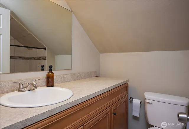 a bathroom with a sink a toilet and a mirror