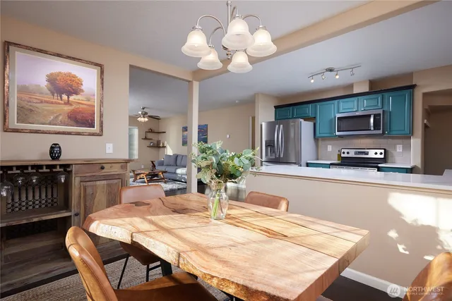 a view of a dining room with furniture and a kitchen