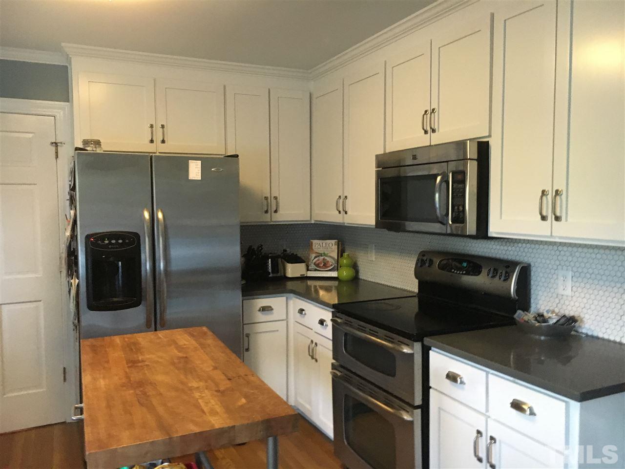 2600 Patriot Place Raleigh, NC 27615 - Photo 3 of 4 a kitchen with stainless steel appliances granite countertop a stove a refrigerator and a microwave