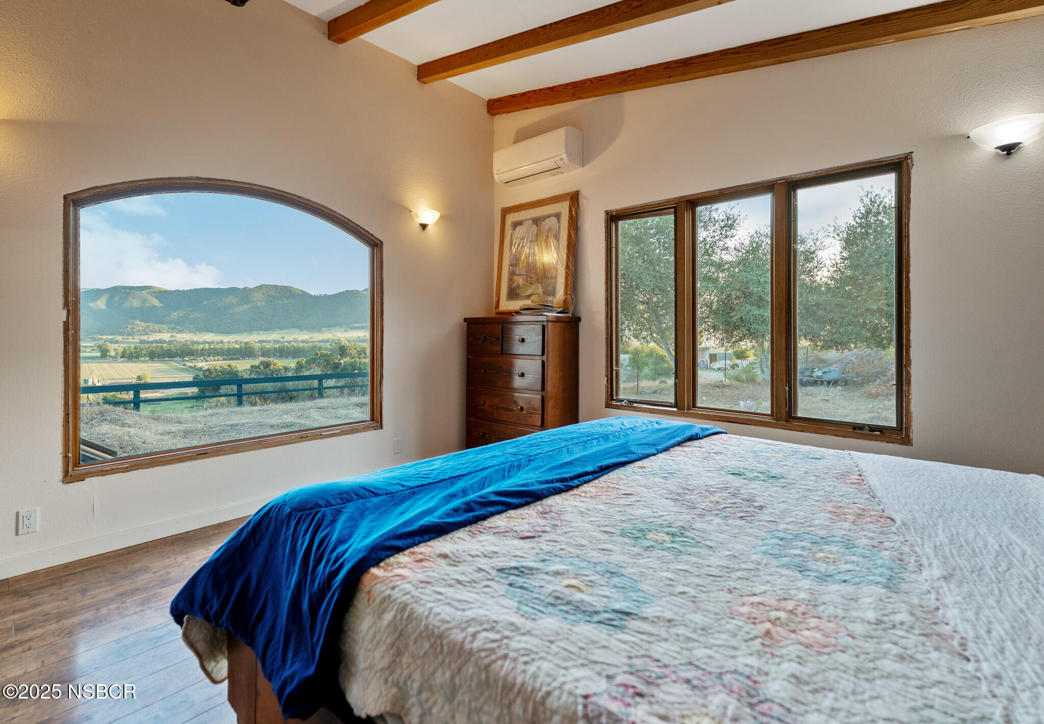 954 Ballard Canyon Road Solvang, CA 93463 - Photo 13 of 17 a view of a bedroom with a large bed and wooden floor