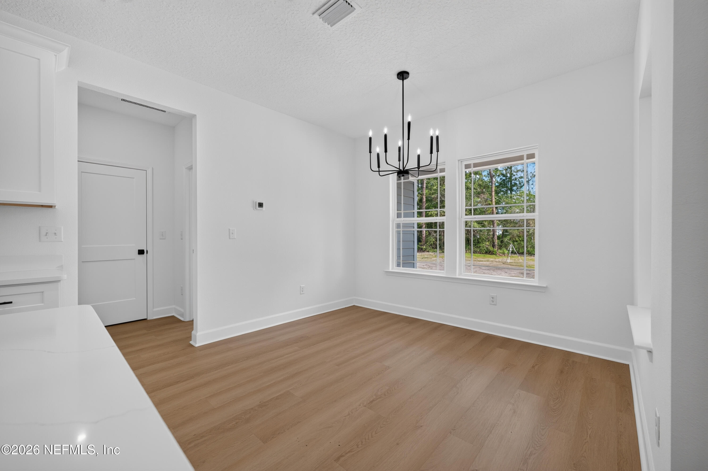 4362 Angora Street Middleburg, FL 32068 - Photo 26 of 31 a view of an empty room with window and wooden floor
