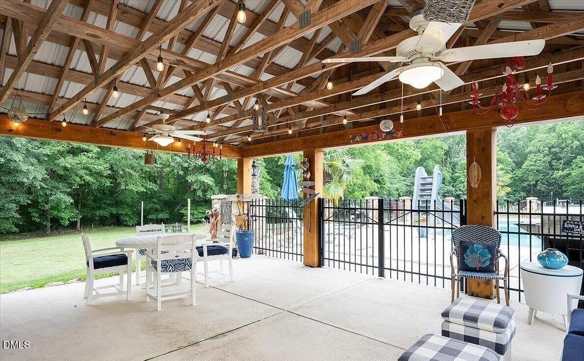 413 Johnson Town Road Zebulon, NC 27597 - Photo 9 of 42 a view of a patio with a table and chairs