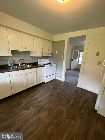 a kitchen with stainless steel appliances granite countertop a sink and cabinets