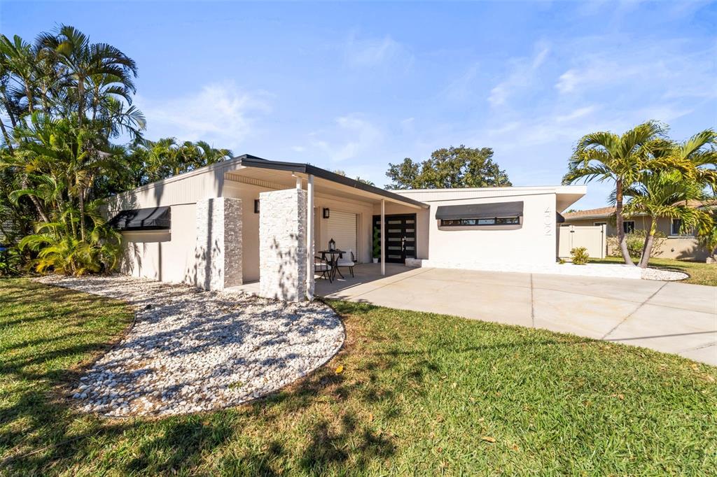 402 161st Avenue Redington Beach, FL 33708 - Photo 14 of 55 a view of a house with a yard and garage