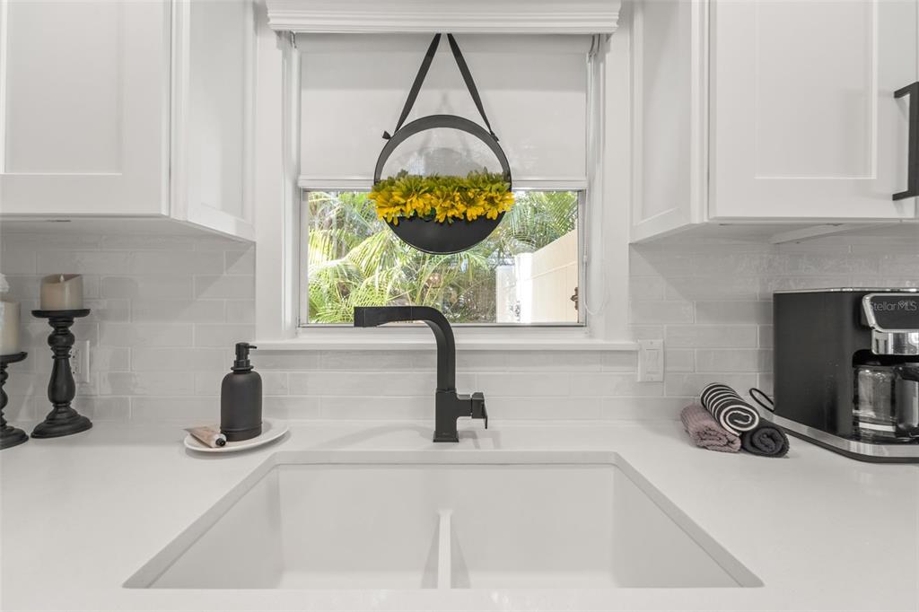 402 161st Avenue Redington Beach, FL 33708 - Photo 16 of 56 a kitchen with a sink and a mirror