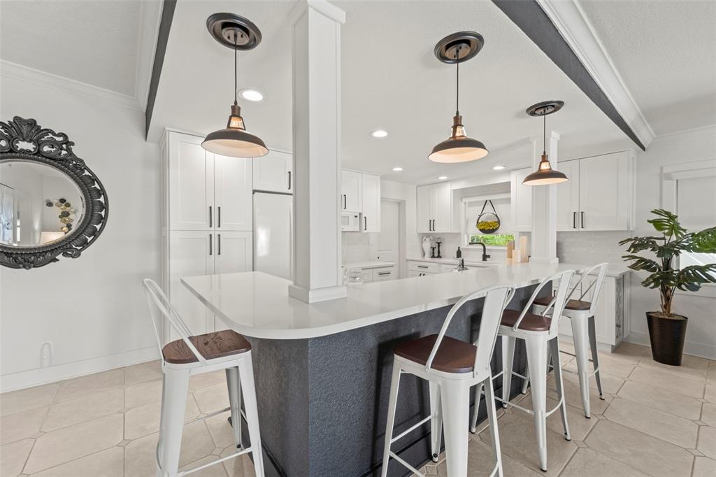 402 161st Avenue Redington Beach, FL 33708 - Photo 18 of 56 a view of a dining room with furniture and a chandelier