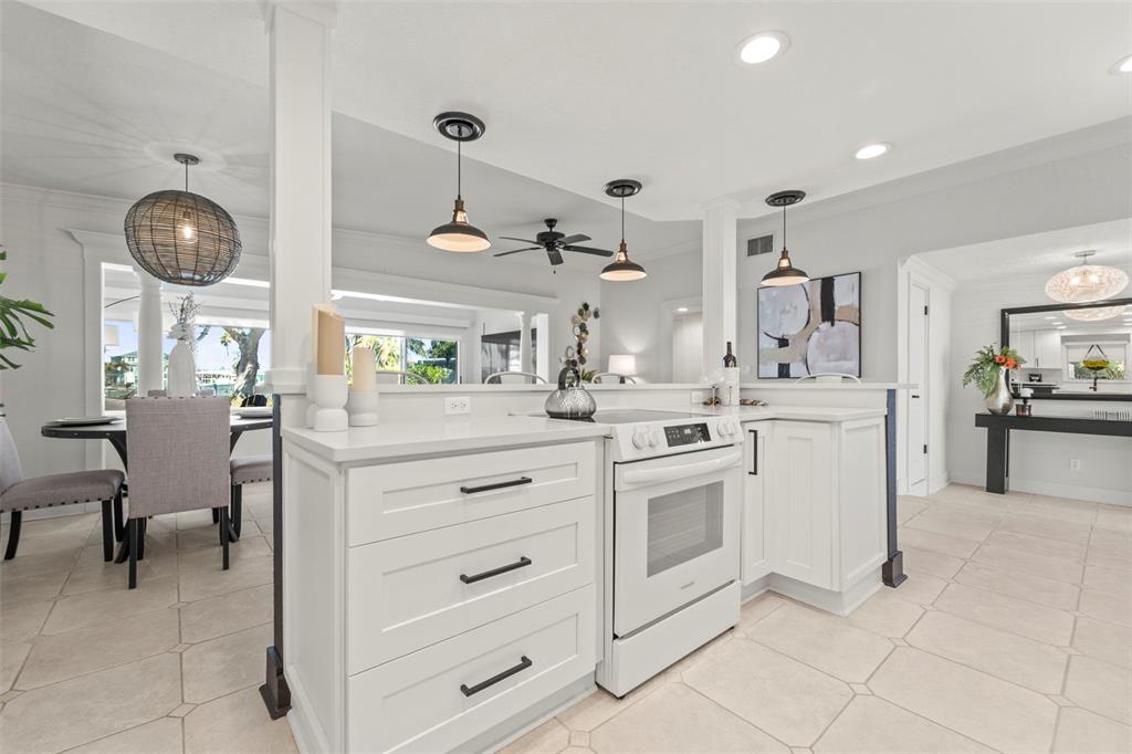 402 161st Avenue Redington Beach, FL 33708 - Photo 20 of 55 a kitchen with cabinets and chairs