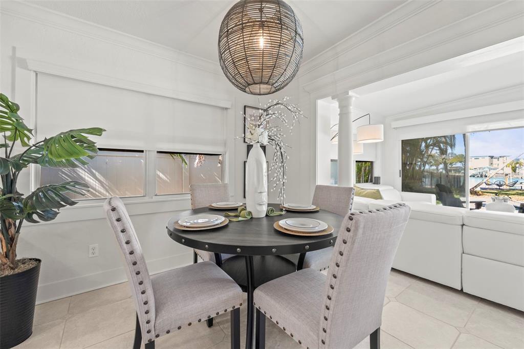 402 161st Avenue Redington Beach, FL 33708 - Photo 24 of 55 a view of a dining room with furniture and chandelier