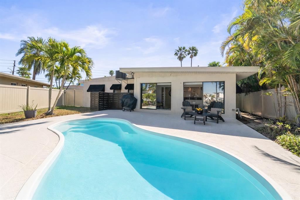 402 161st Avenue Redington Beach, FL 33708 - Photo 30 of 55 a view of a house with swimming pool and sitting area