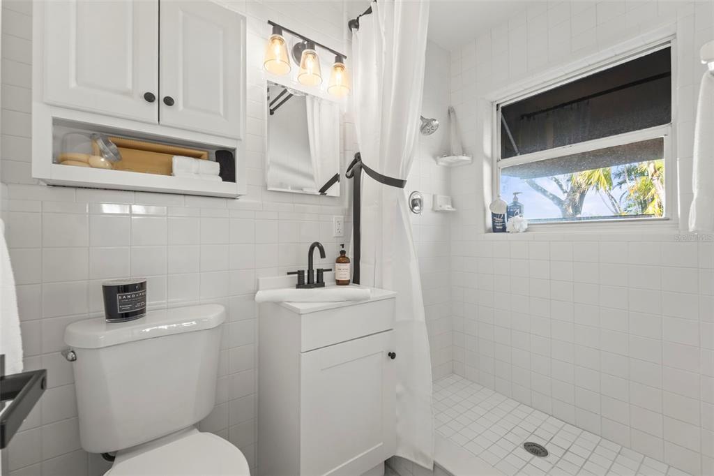 402 161st Avenue Redington Beach, FL 33708 - Photo 31 of 56 a bathroom with a toilet sink and mirror