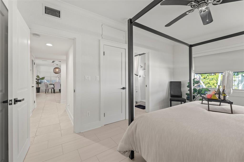 402 161st Avenue Redington Beach, FL 33708 - Photo 32 of 55 a bedroom with a bed and a chandelier