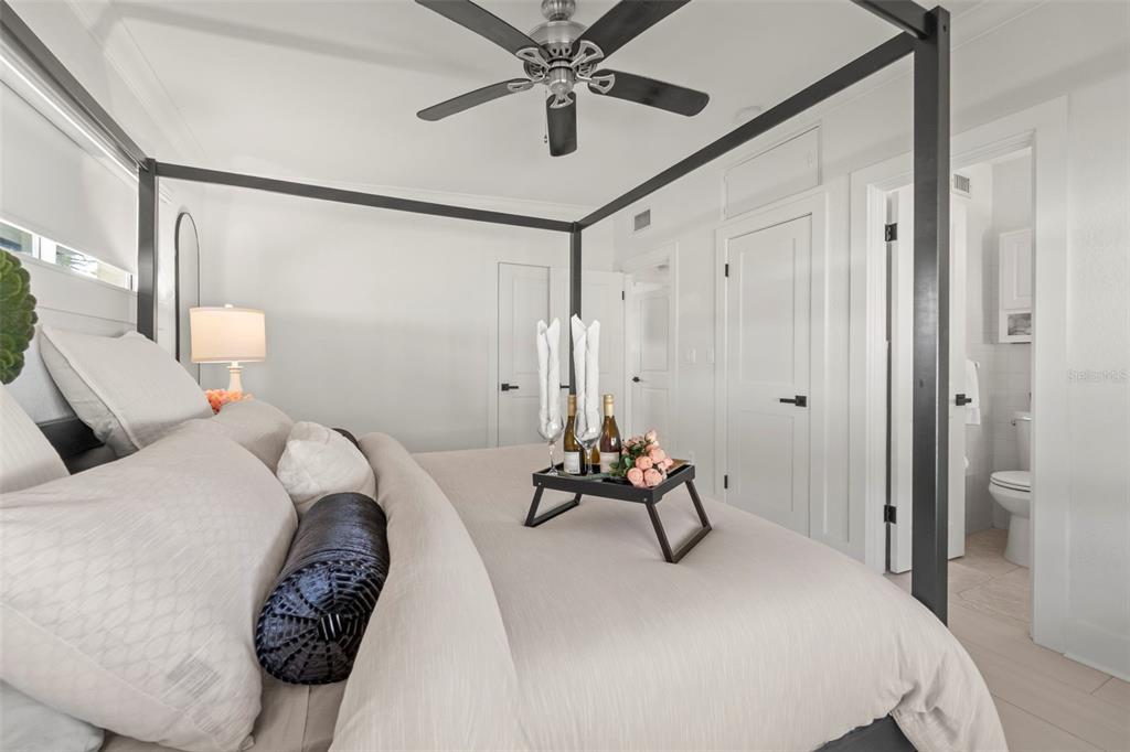 402 161st Avenue Redington Beach, FL 33708 - Photo 33 of 55 a bedroom with a bed and a chandelier